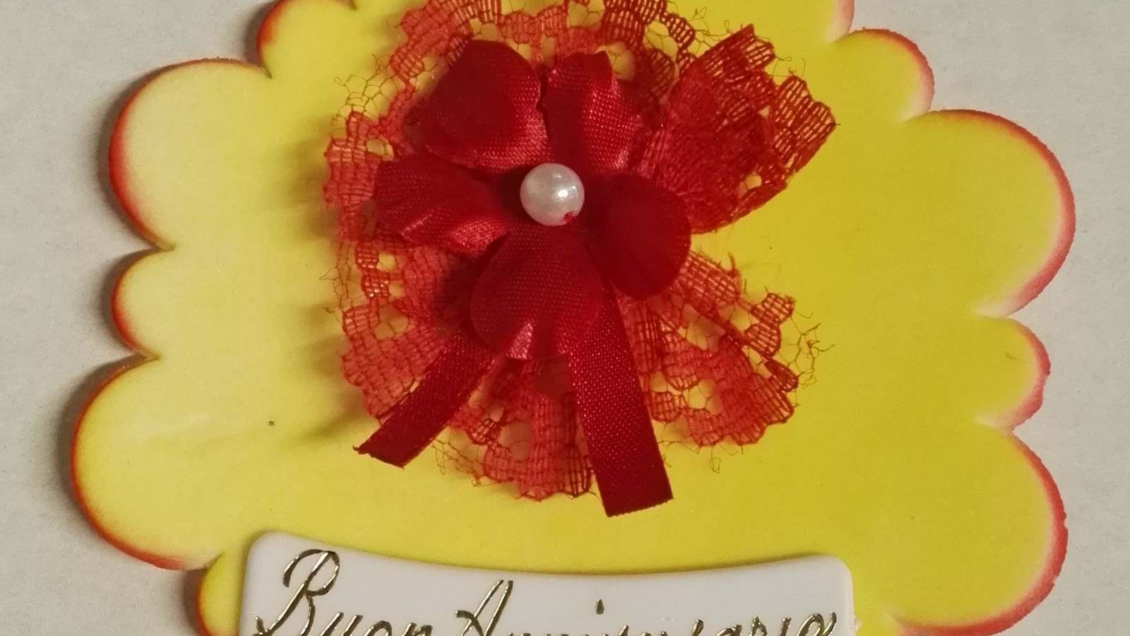 taghetta buon anniversario con fiore